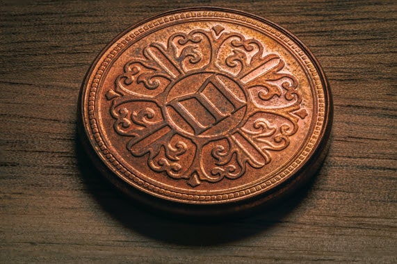 A custom coin resting on an office desk